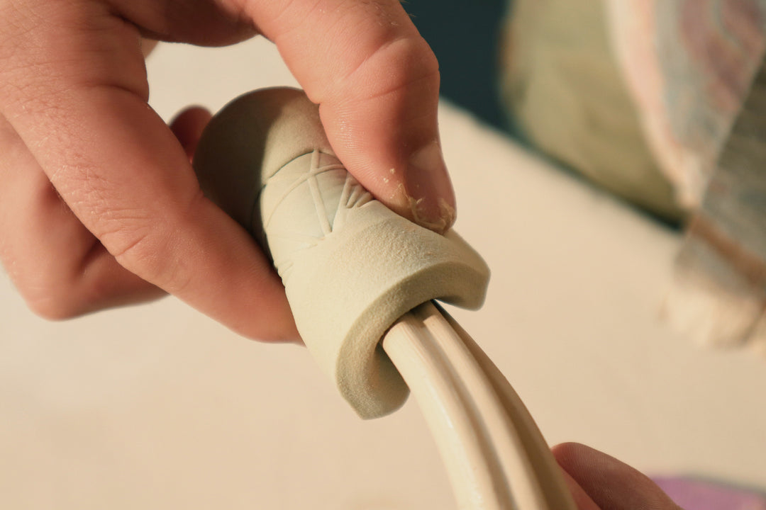 Pottery sponge being used on clay
